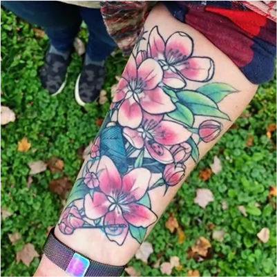 Healed cherry blossom scar coverup tattoo with delicate floral elements